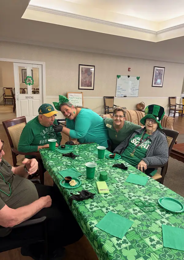 Residents sitting around table with St. Patrick day decorations